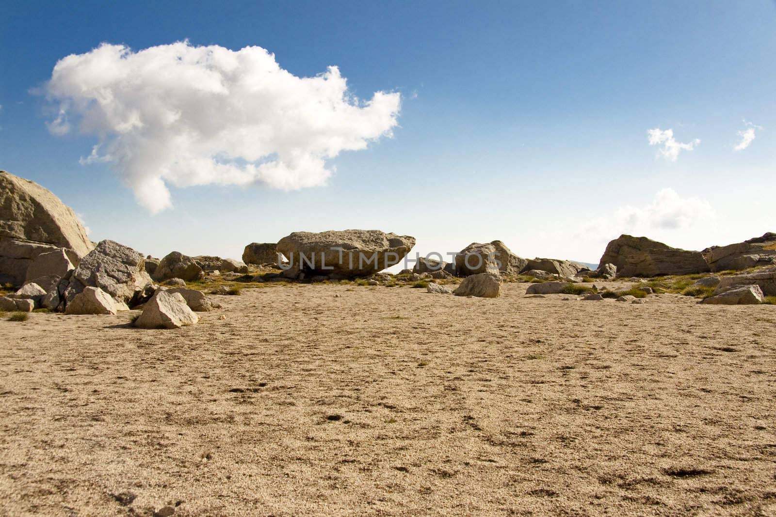 Sandy and falt mountain pass in Aiguestortes National Park - Spain. White clouds and blue sky