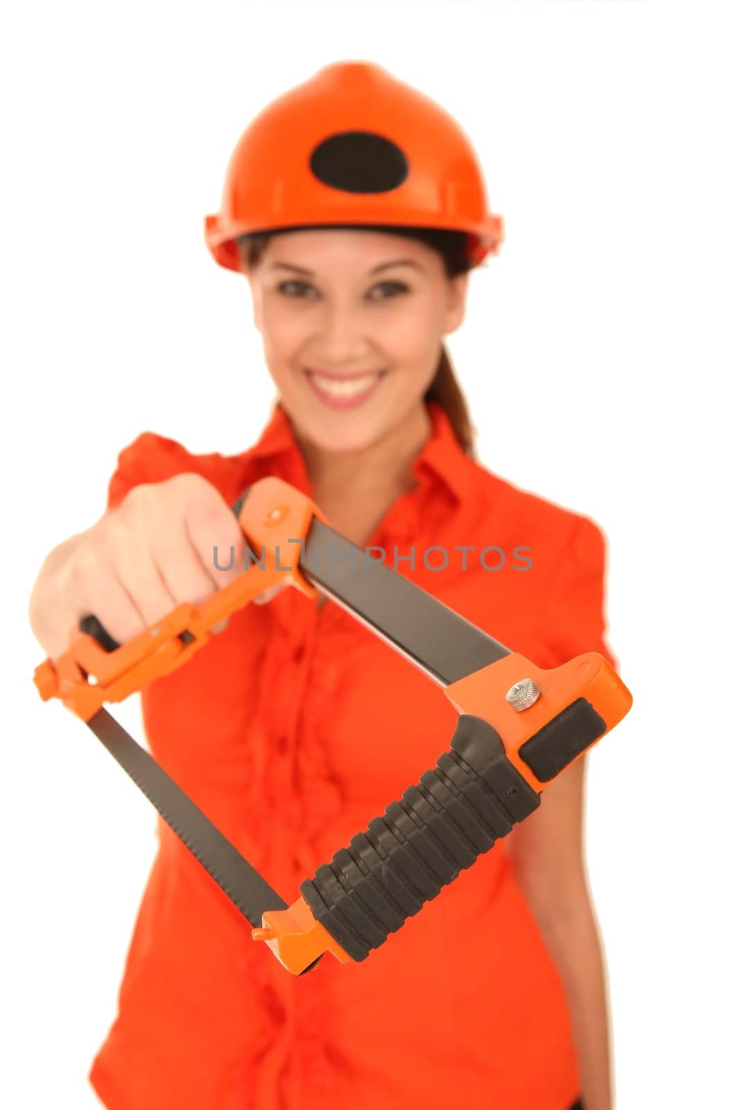 Pretty female worker in helmet and with hacksaw - focus on saw
