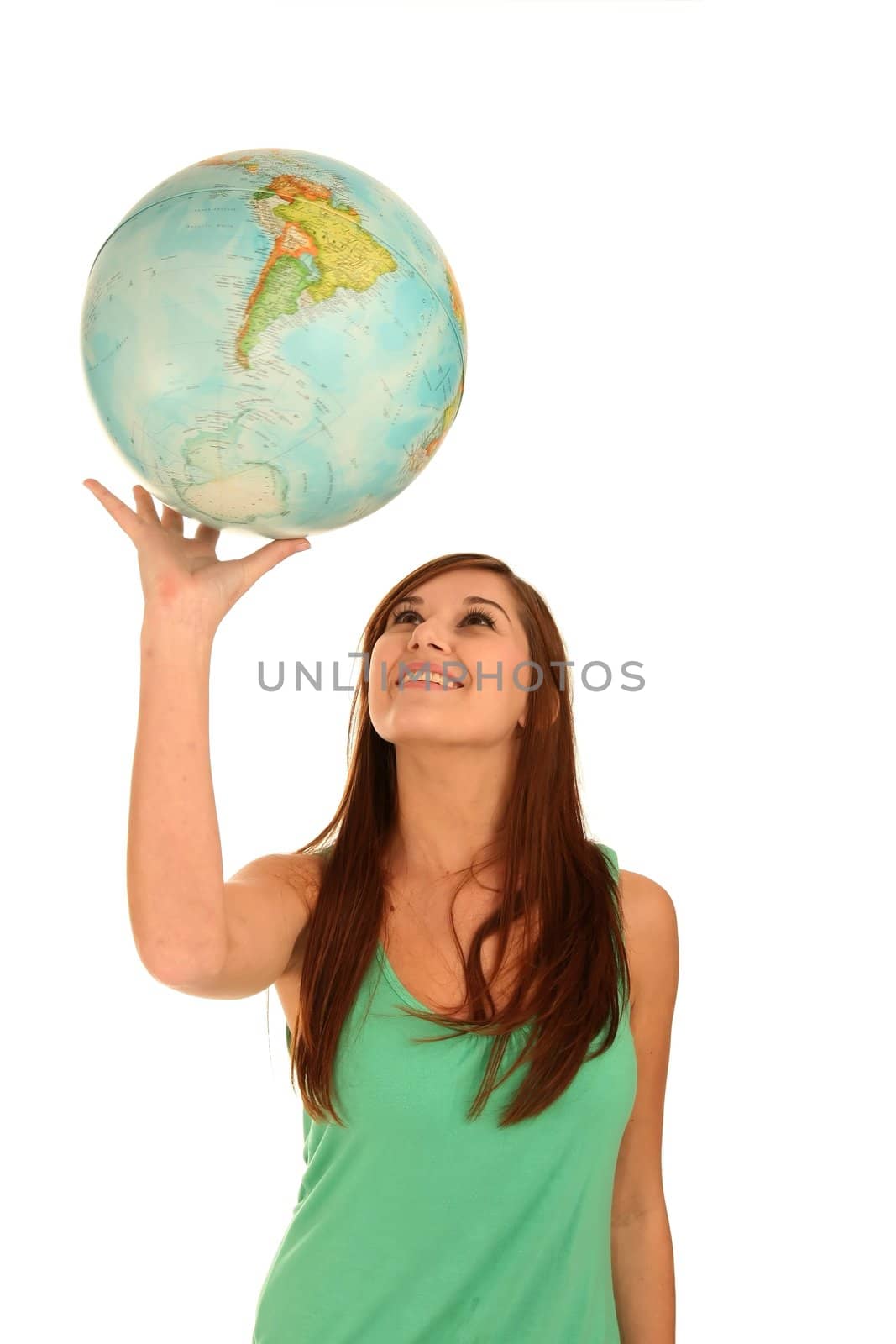 Pretty smiling young woman spinning the globe on her hand