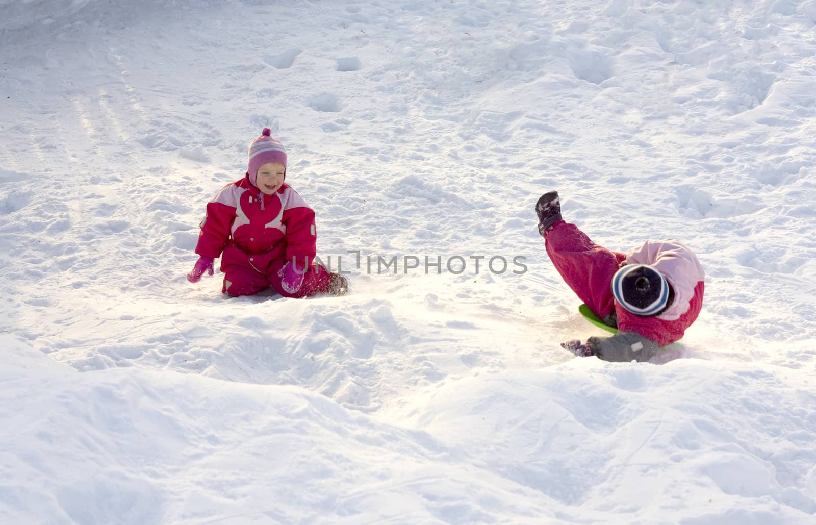 Two happy children playing in the snow
