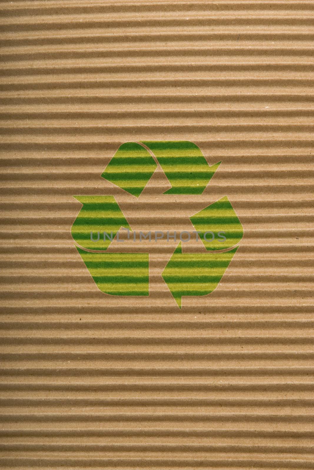 brown corrugated cardboard texture, striped horizontally paper and green recycling sign