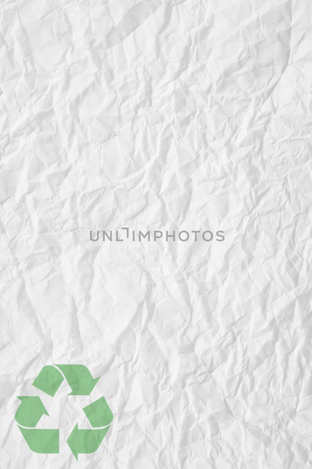 texture of white crumpled paper and green recycling sign
