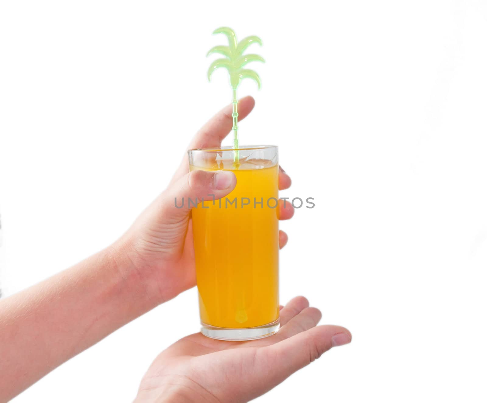 A glass of orange cocktail in children's hands on a white background.