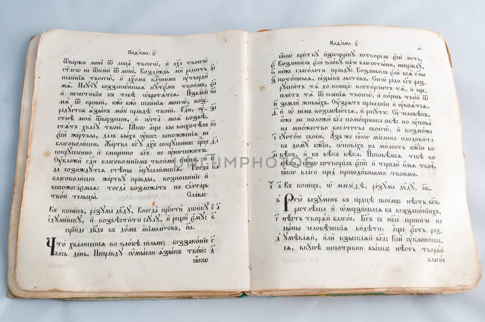 Opened old religious book with  text on Church Slavonic language isolated on white background .