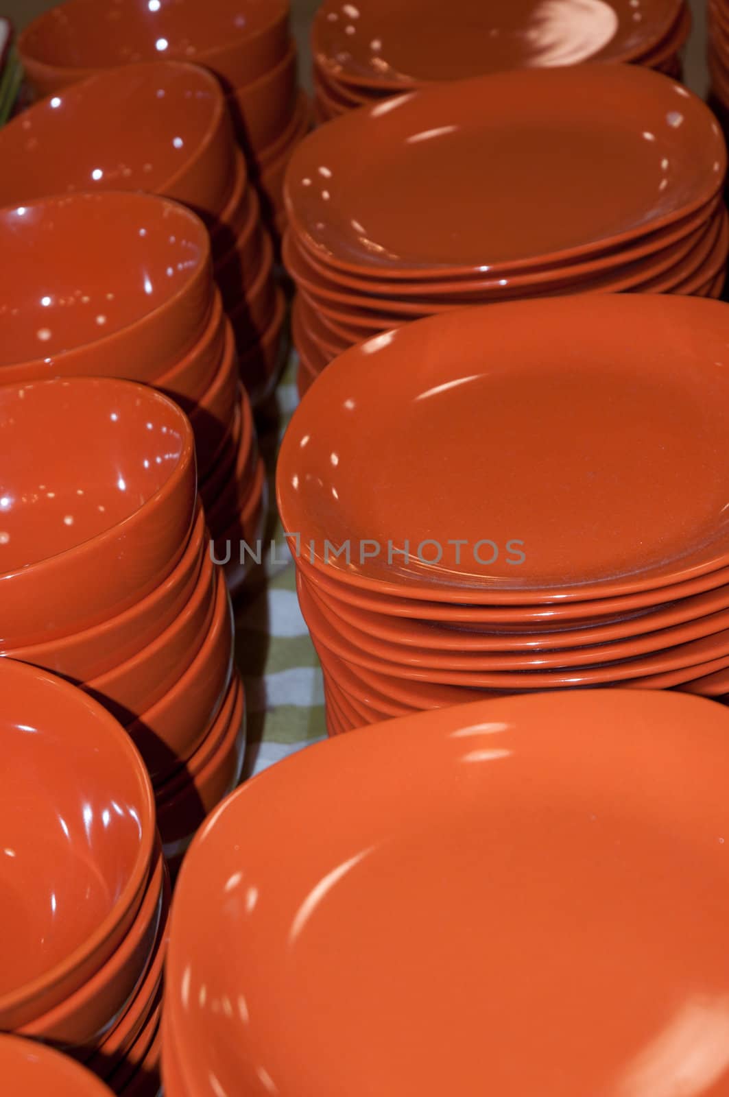 A view from a stacks of clean  dishes .