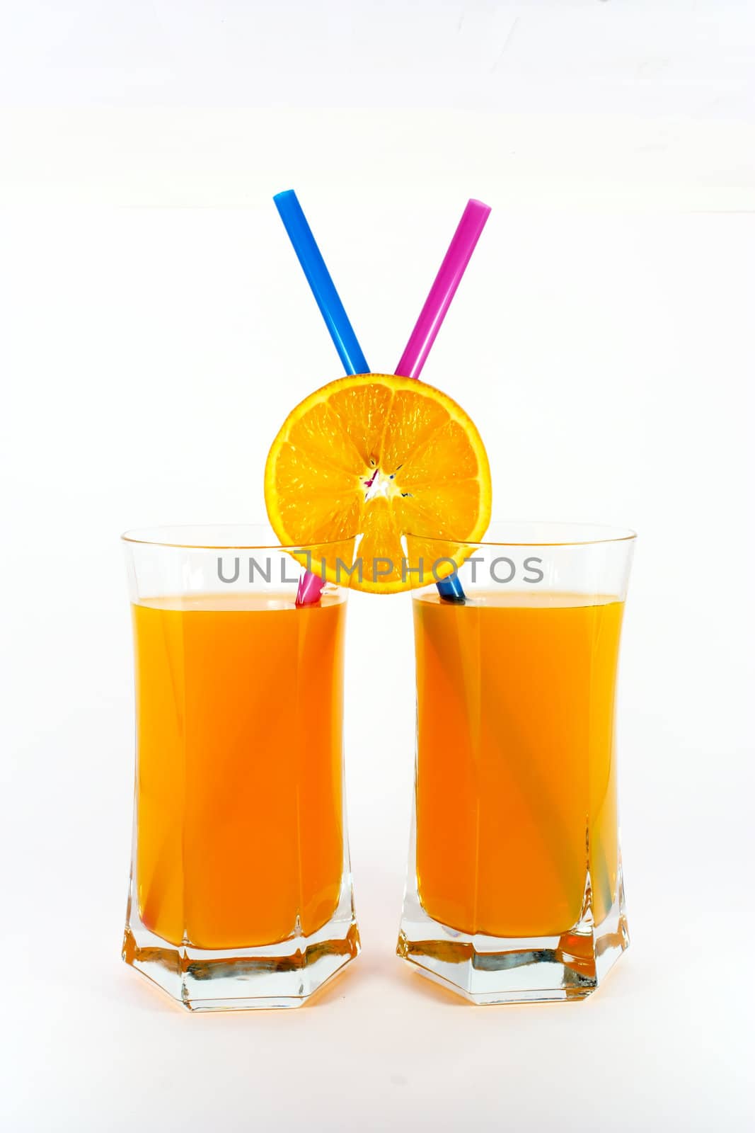 Two glasses of fresh orange juice isolated on white