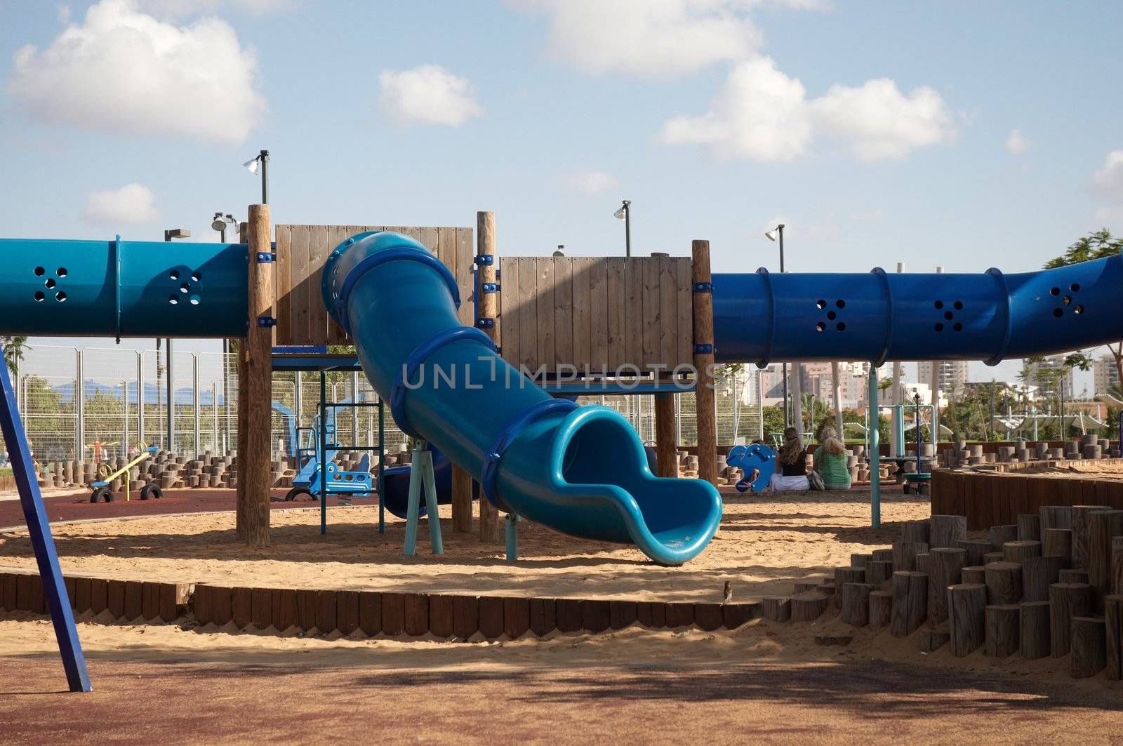 A view from a colorful playground under a beautiful clean blue sky .