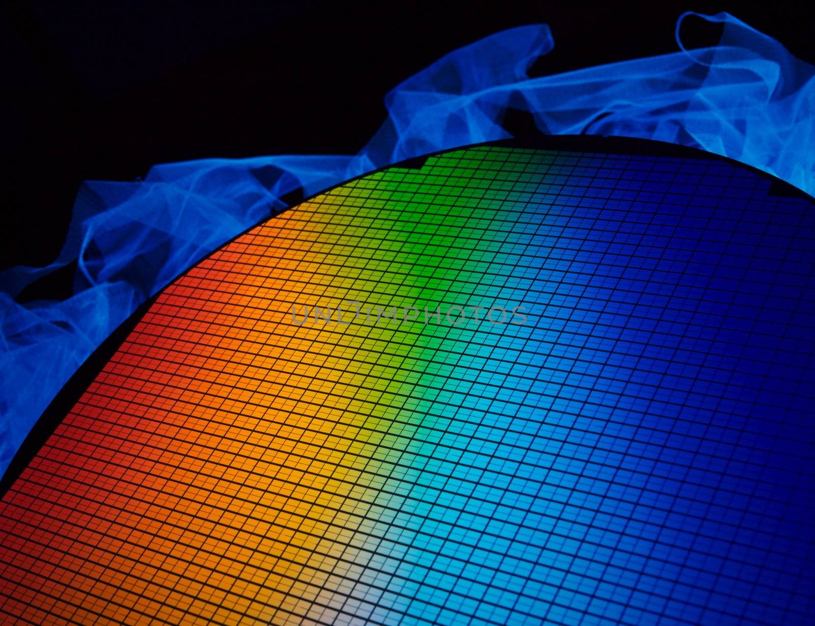 detail of a silicon chip wafer reflecting different colors