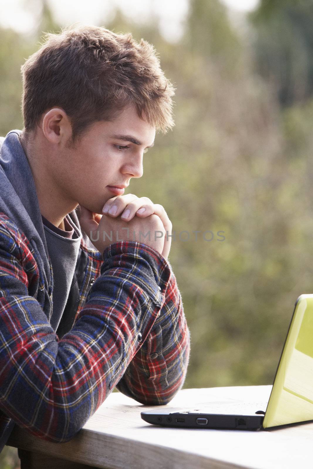 Young man with laptop computer by omg_images