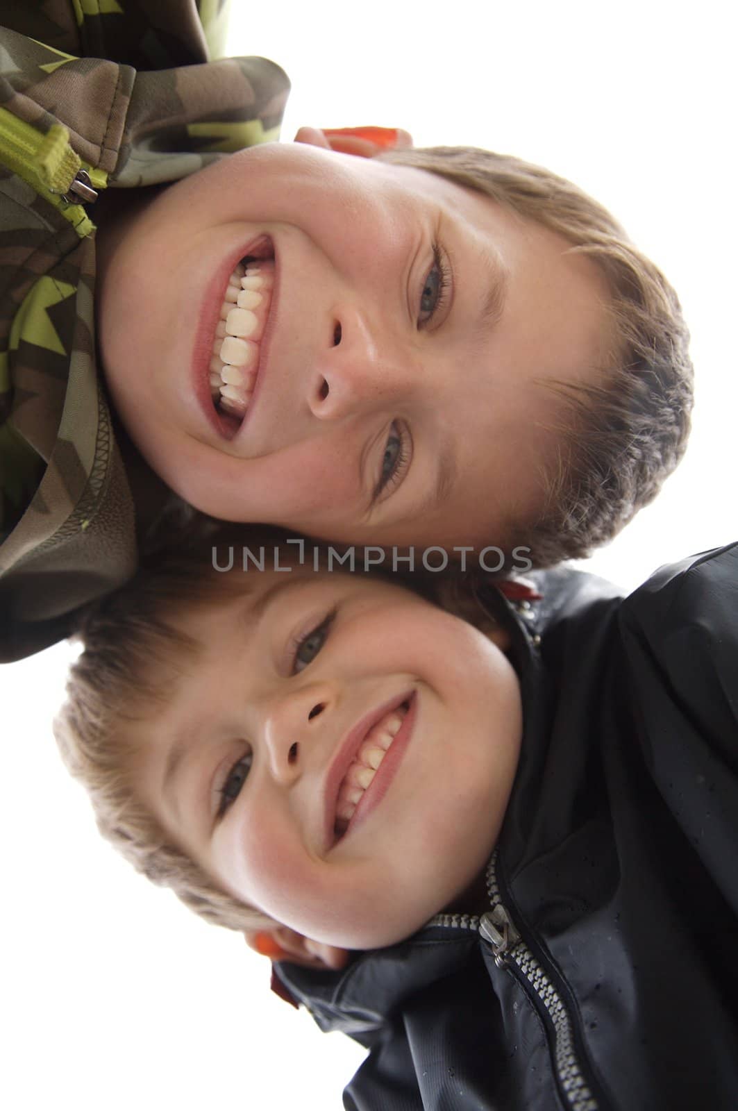 two cute young boys with a teethy smile