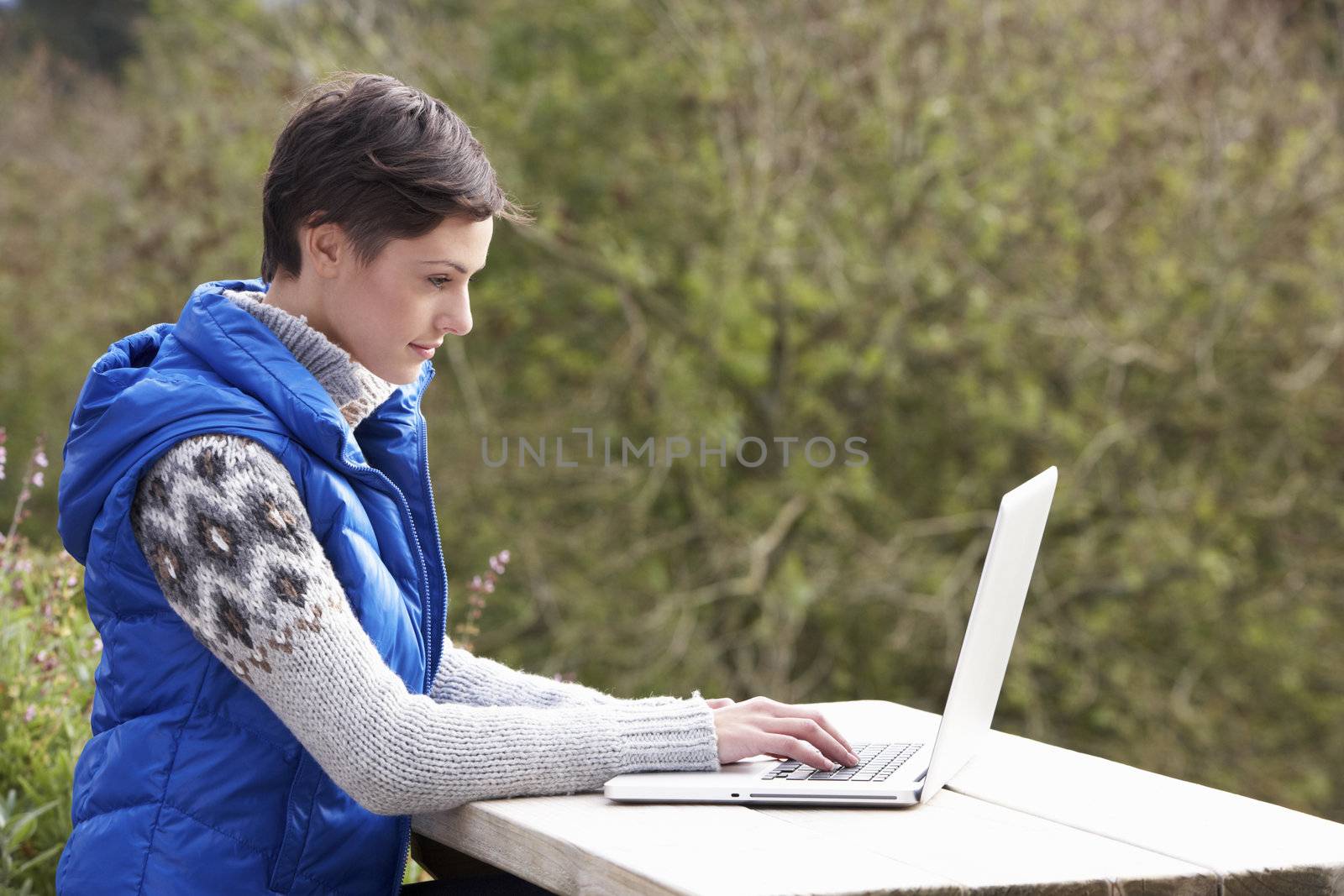 Young woman with laptop computer by omg_images