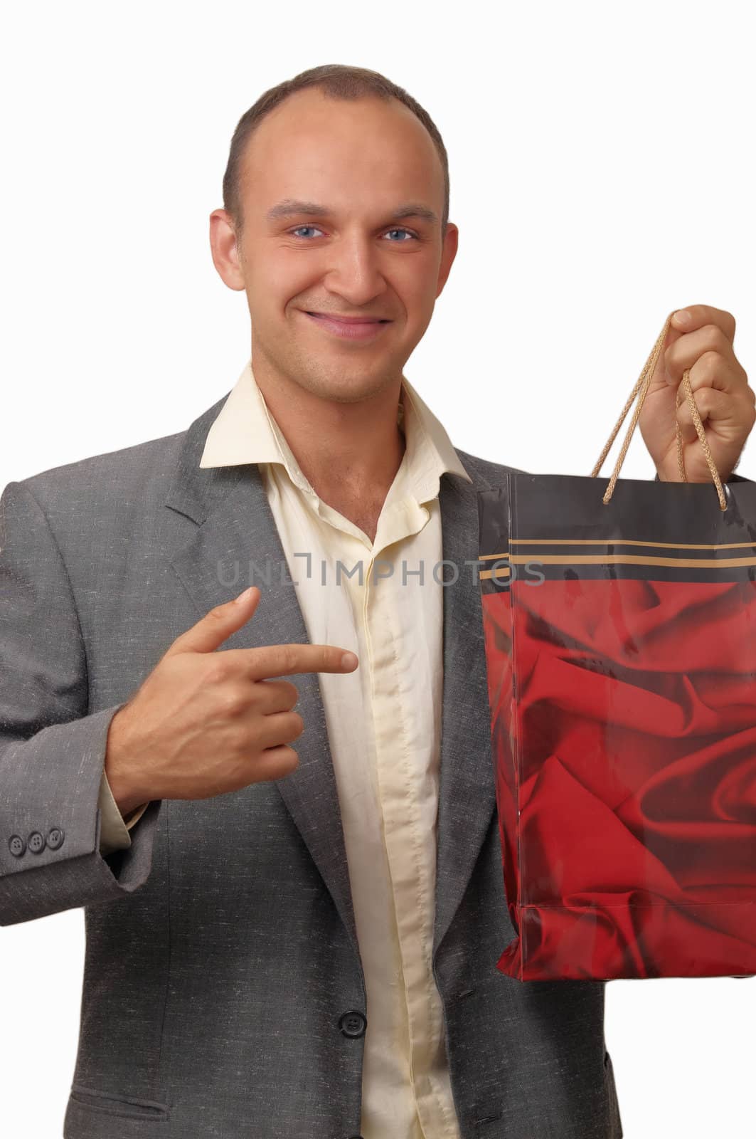 A young man wearing a jacket with a gift bags .