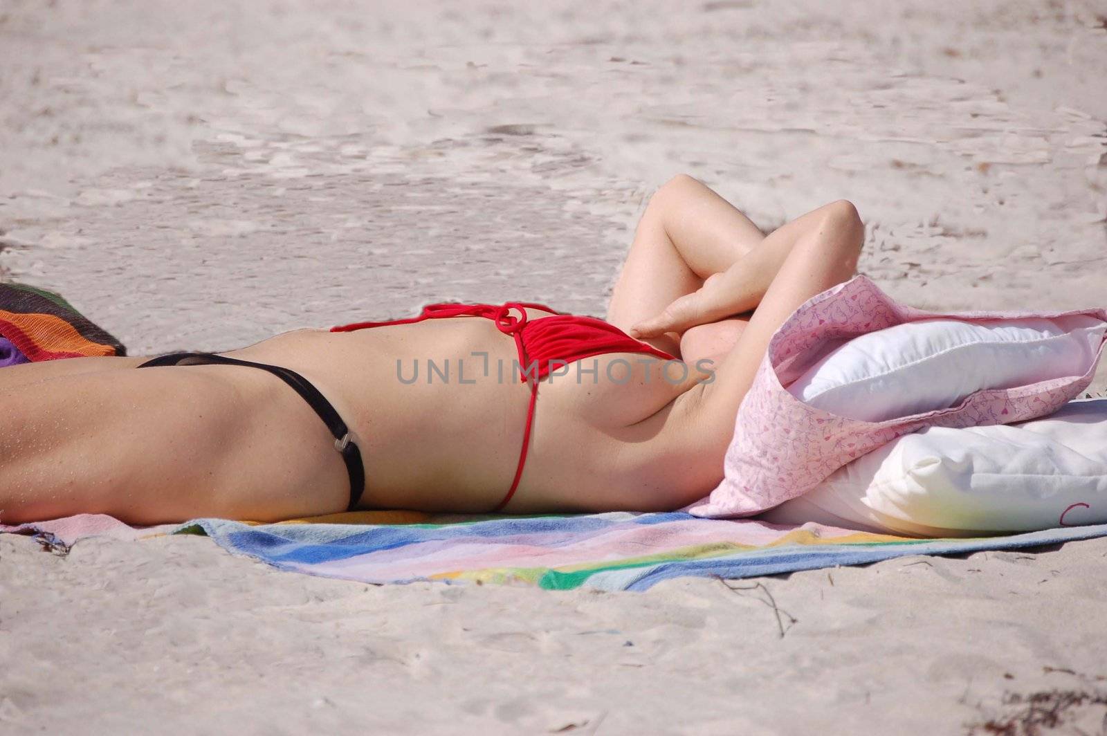Candid shot of a voluptous woman sunbather at sunset on Virginia Key beach near Key Biscayne,Florida