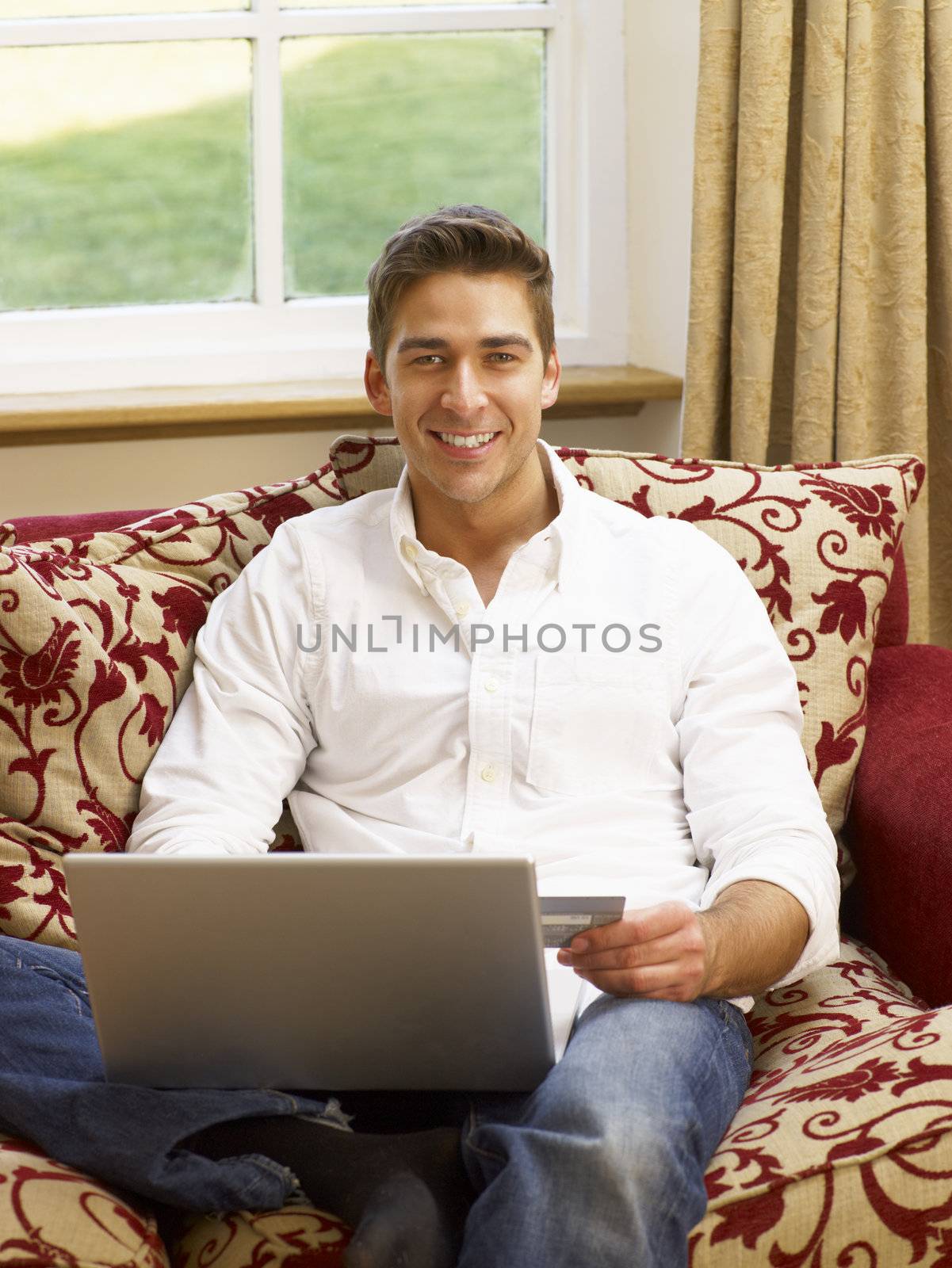 Young Hispanic couple shopping online by omg_images