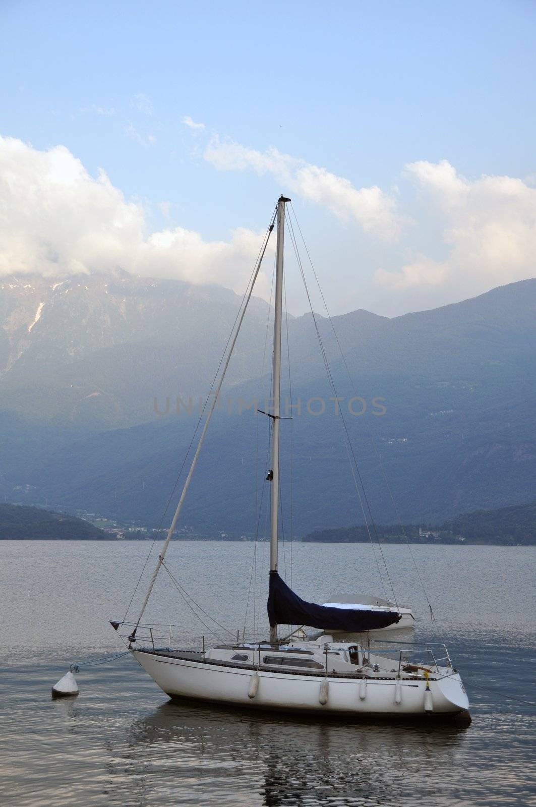 Large sailing boat tied to buoy in sunset on Lake Como, Italy