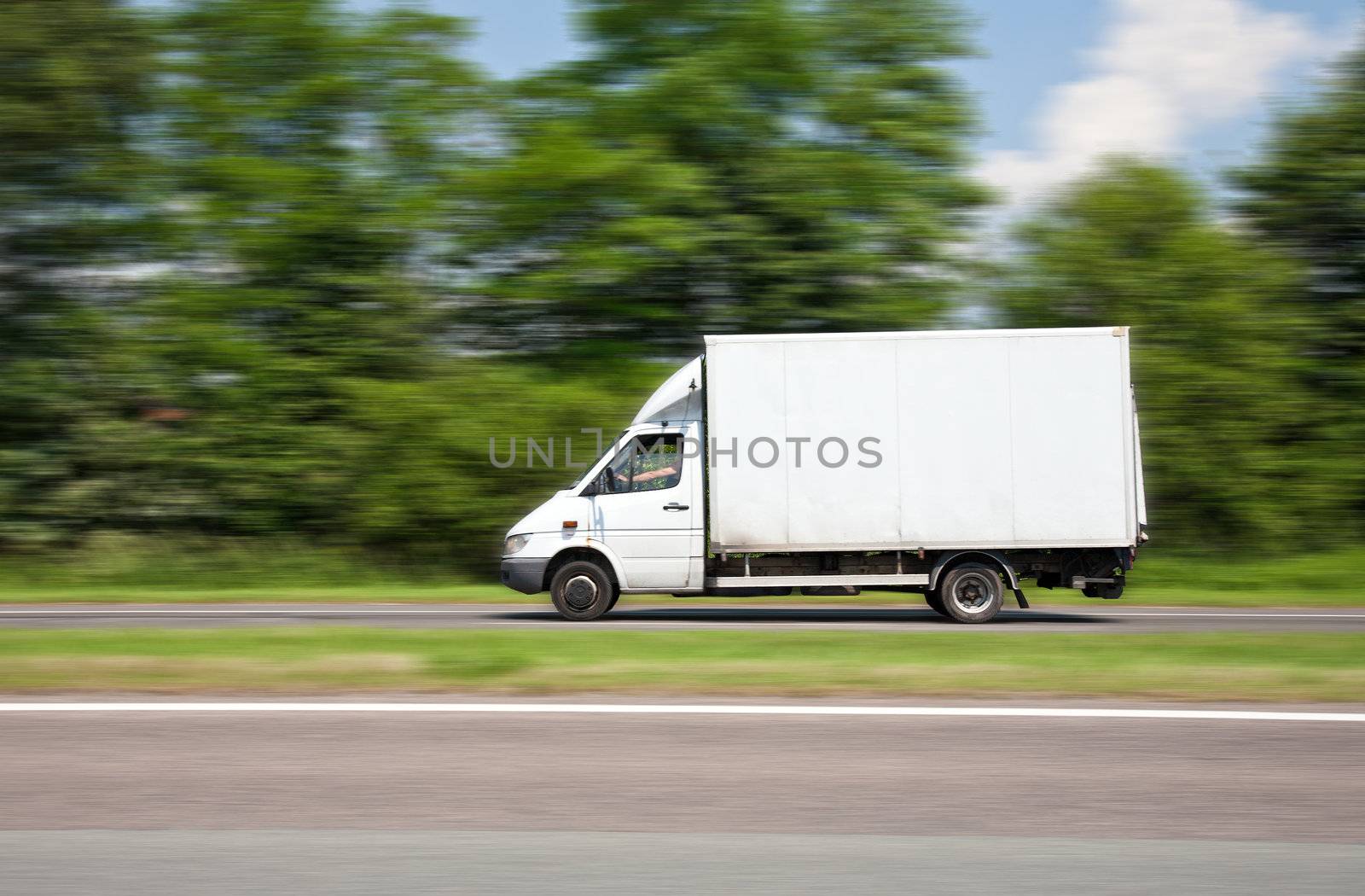 White delivery van driving fast.