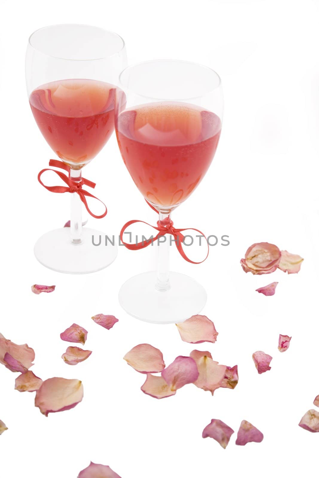 two red wine and rose petals on white background