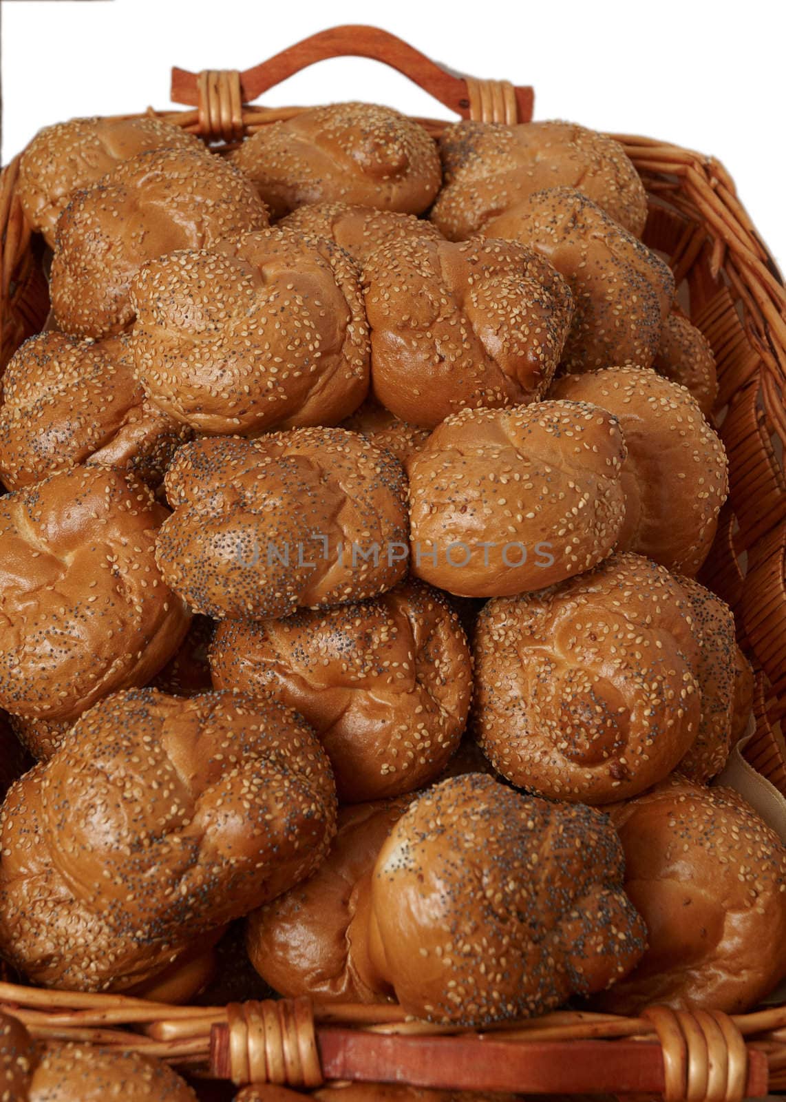 Fresh bread rolls in a wicker basket on a white background.