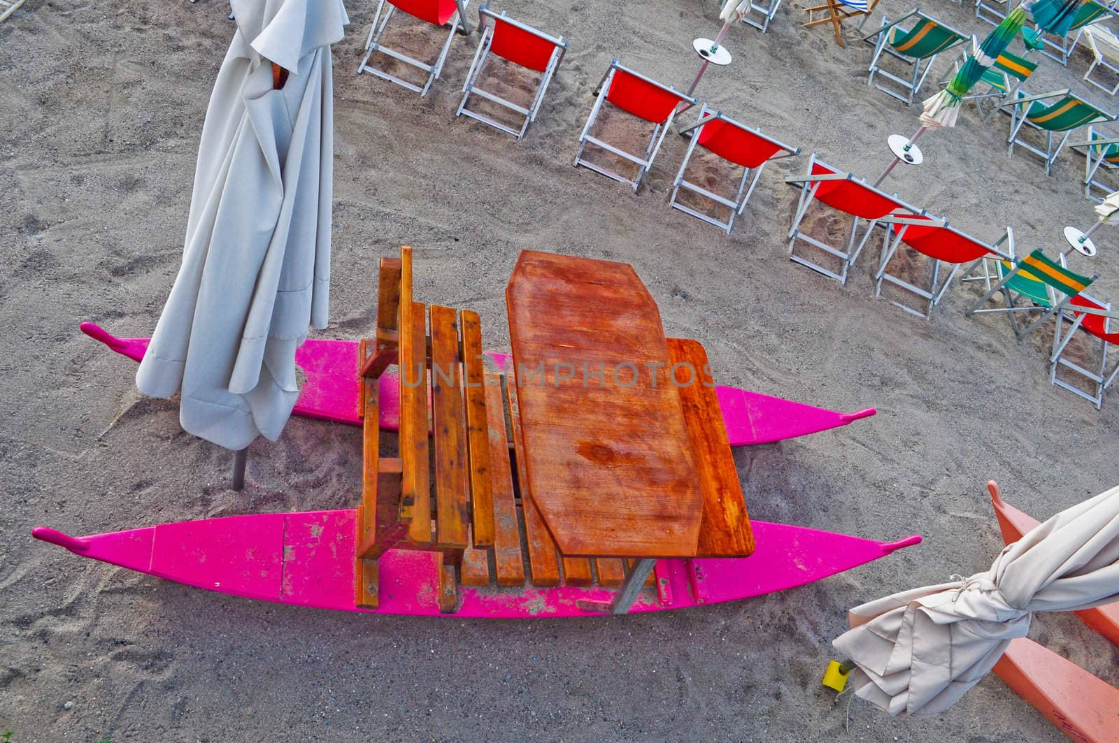 Shore beach with sun umbrella and deckchairs