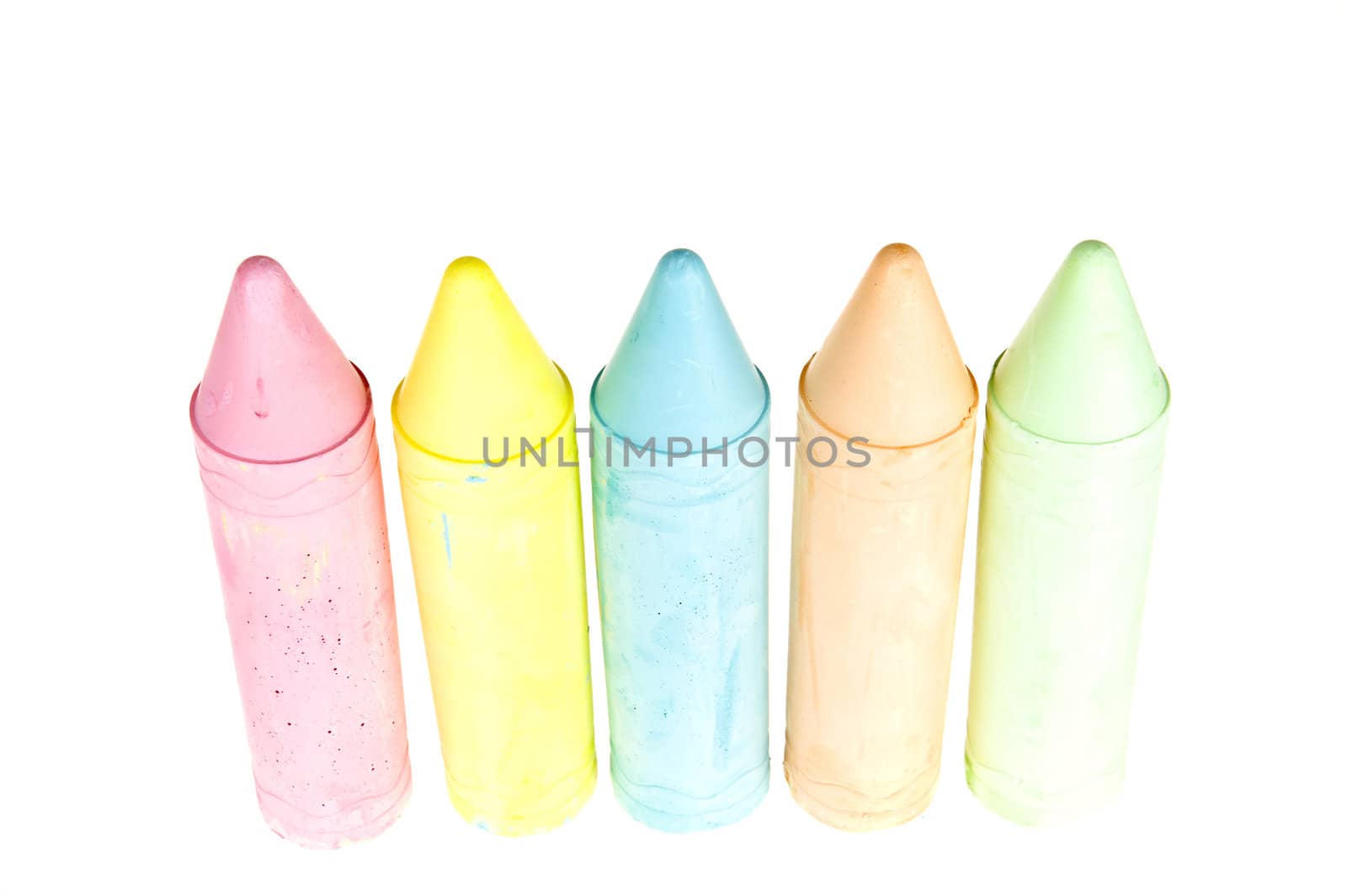 five colorful chalks on a white background