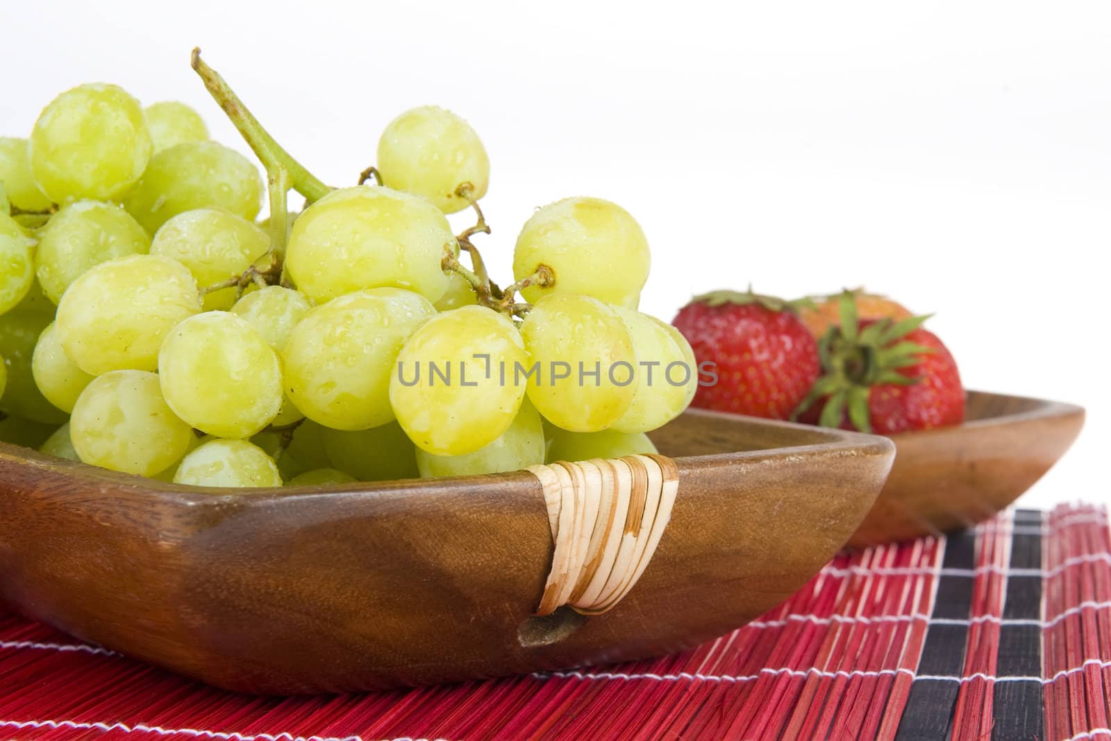 grapes in a wooden tray and strawberries