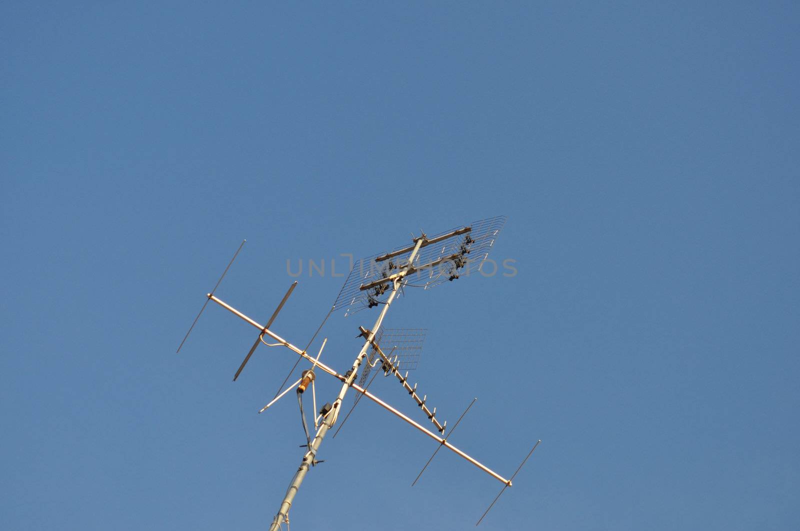 Detail of TV aerial antenna over a blue sky