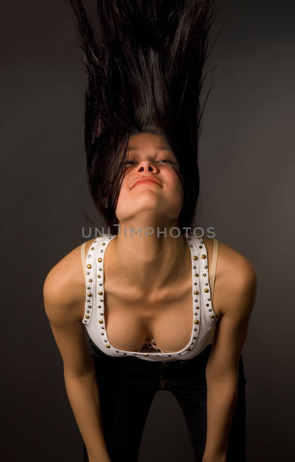 Beautiful girl shaking her head isolated on black background