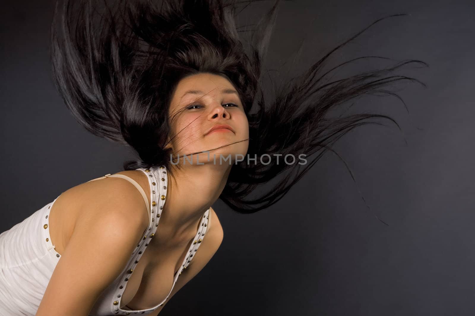 Attractive girl shaking her head isolated in studio