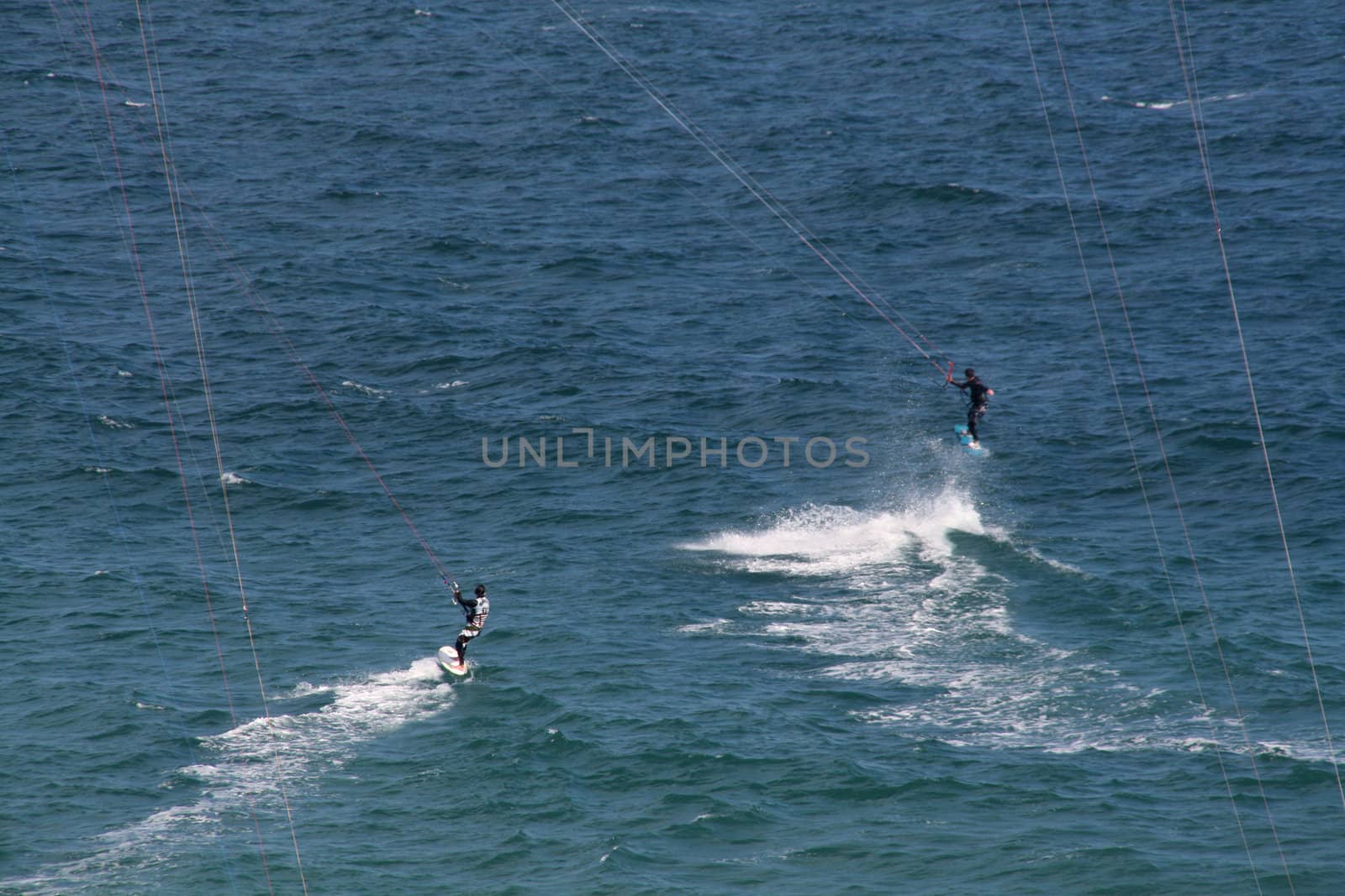 people doing kitesurf sport on holiday at a beach
