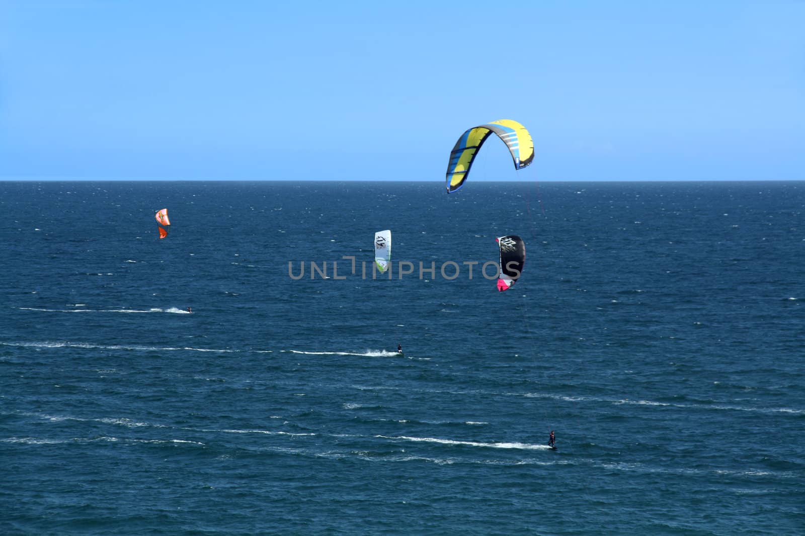 people doing kitesurf sport on holiday at a beach
