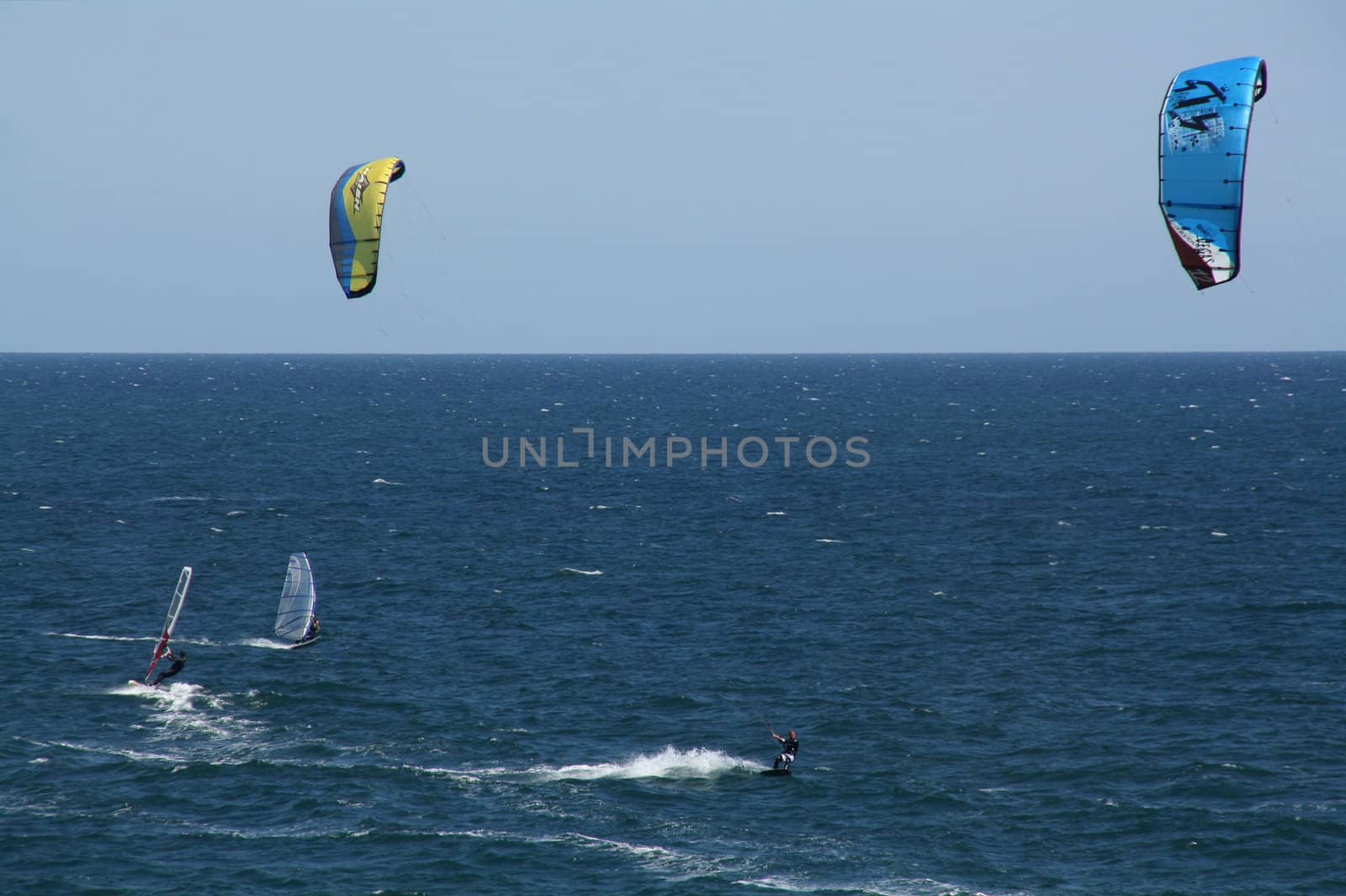 people doing kitesurf sport on holiday at a beach
