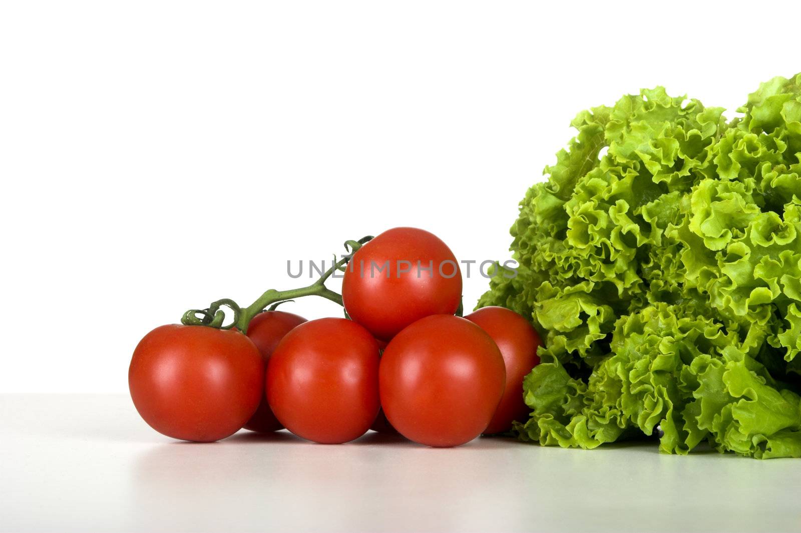 Healthy lettuce and tomatos over a white table