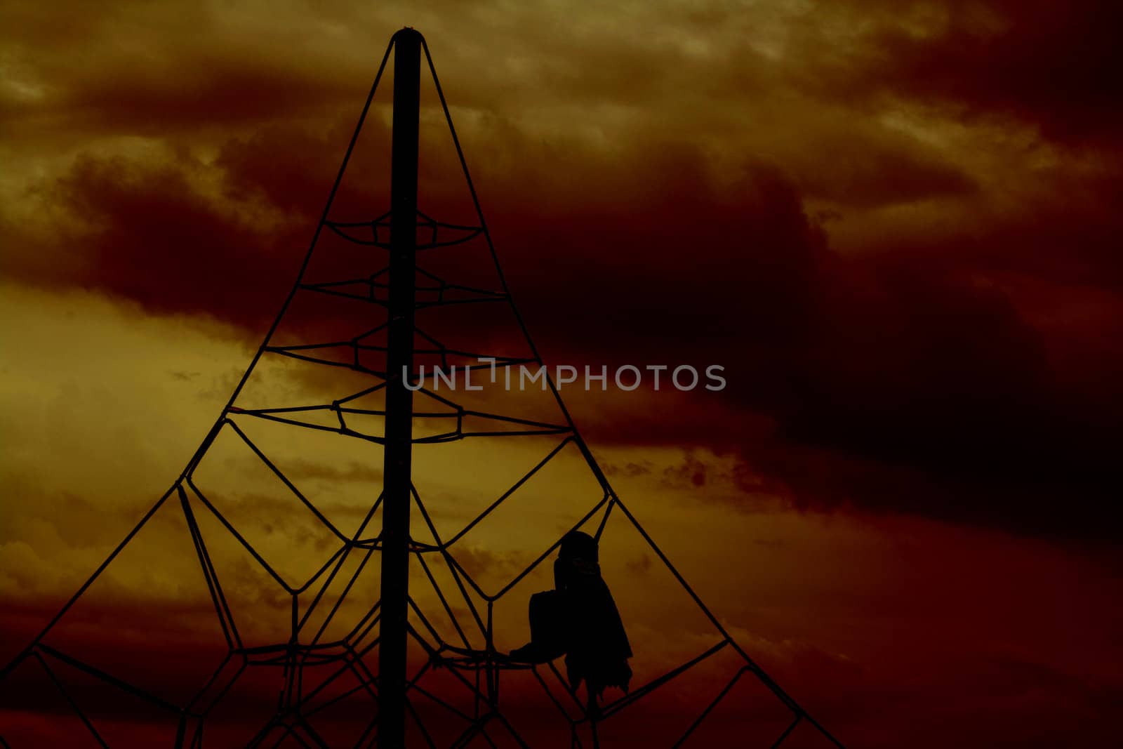 girl playing at the beach with a stormy sunset background
