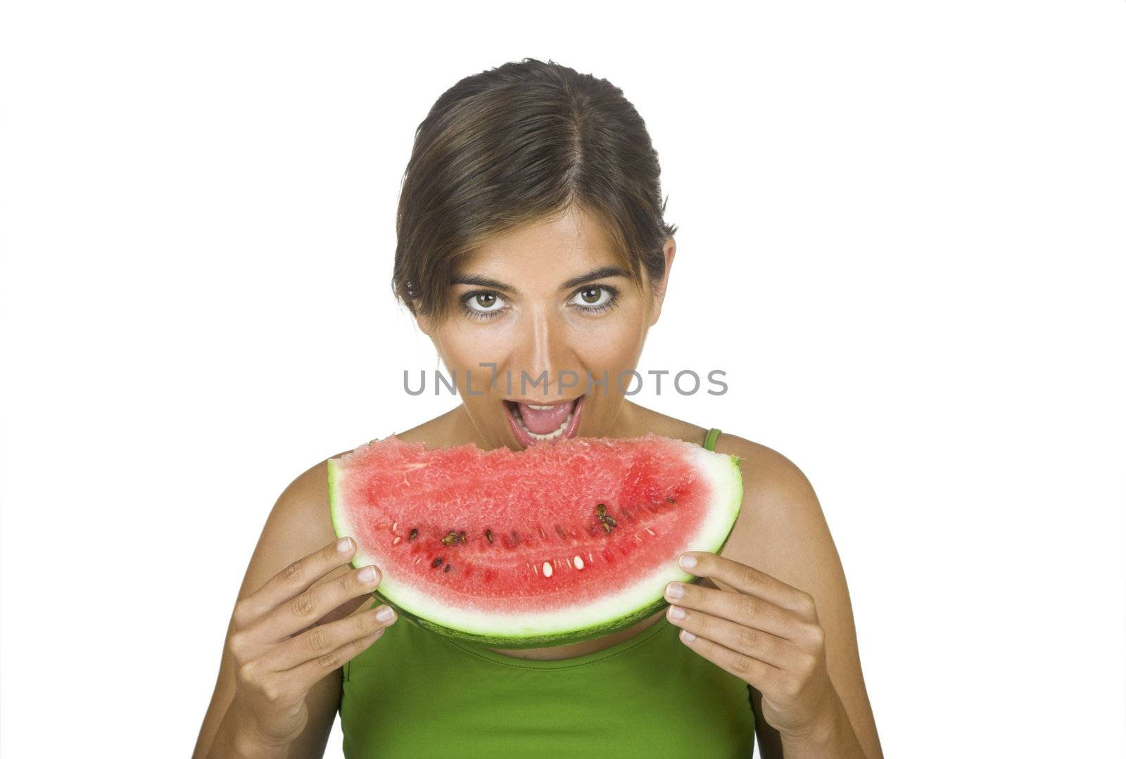 Beautiful young woman eating a slice of watermellon