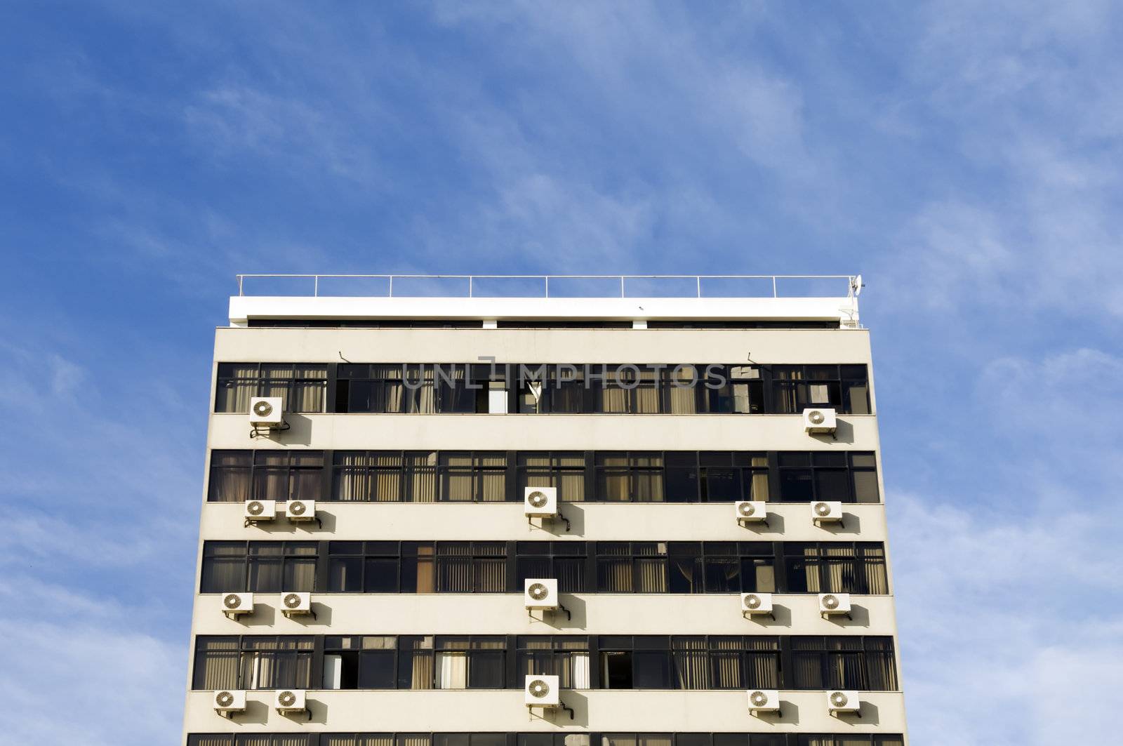 Drab, boring old building with air conditioning units in windows