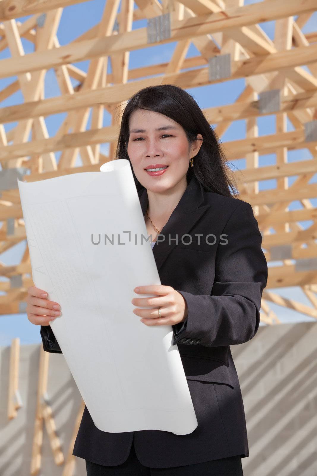 Asian woman contractor with a set of plans by Orchidflower