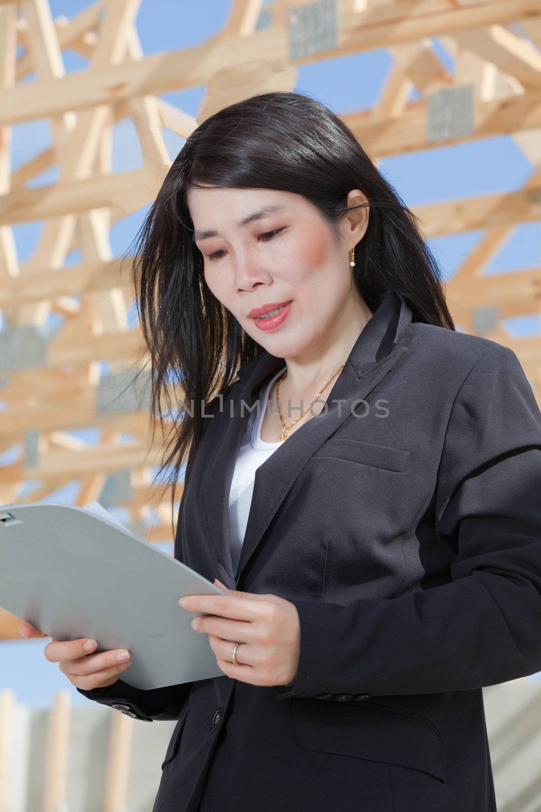 Asian woman contractor with a set clipboard  by Orchidflower