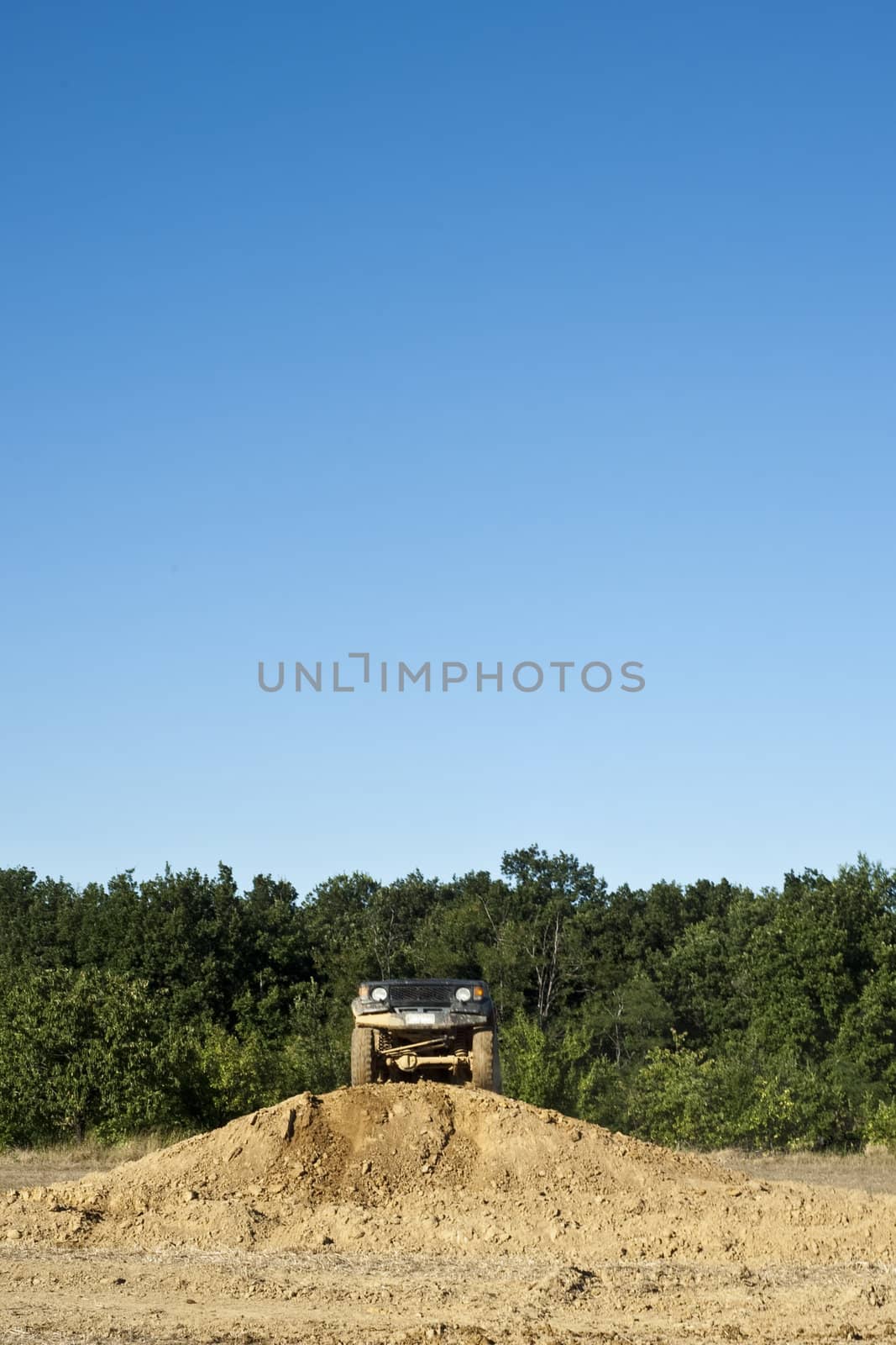Jeep coming out of a muddy hole during a demonstration