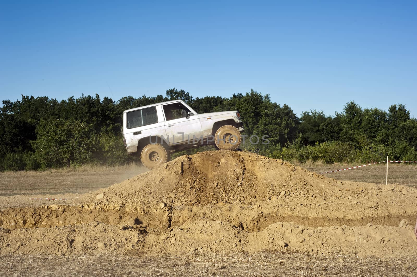 Jeep coming out of a muddy hole during a demonstration