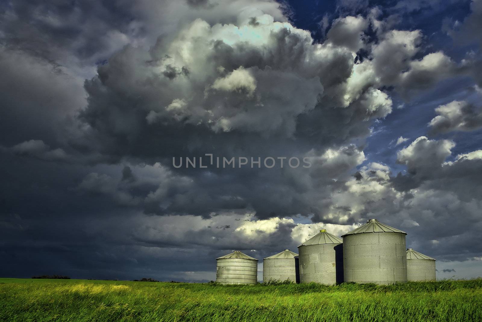 Threatening, powerful clouds over grain silos in Alberta, Canada on a stormy late afternoon.