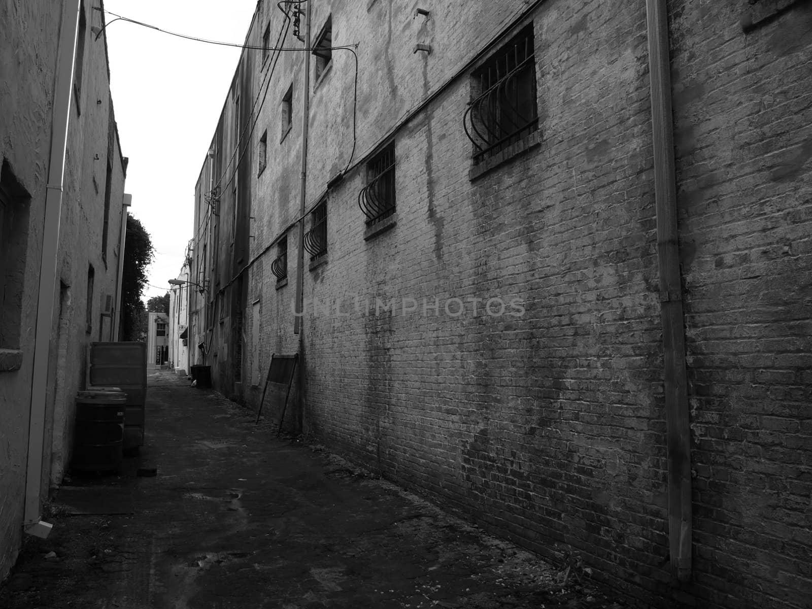 An alleyway in a southern city. Shown in black and white.