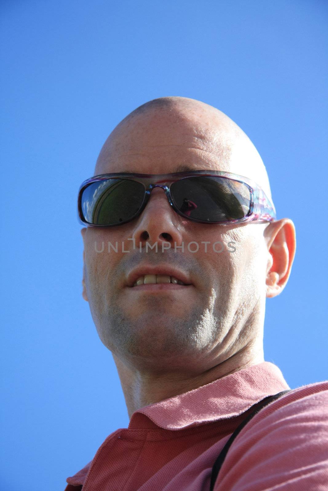 A bold caucasian man wearing sunglasses