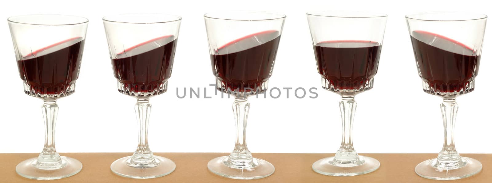 Five wineglasses on a line by cfoto