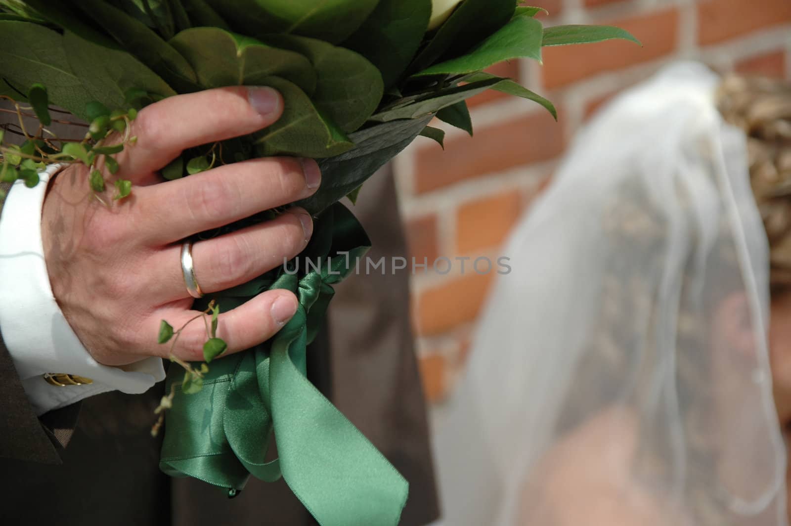 Groom is holding the birds flowers.