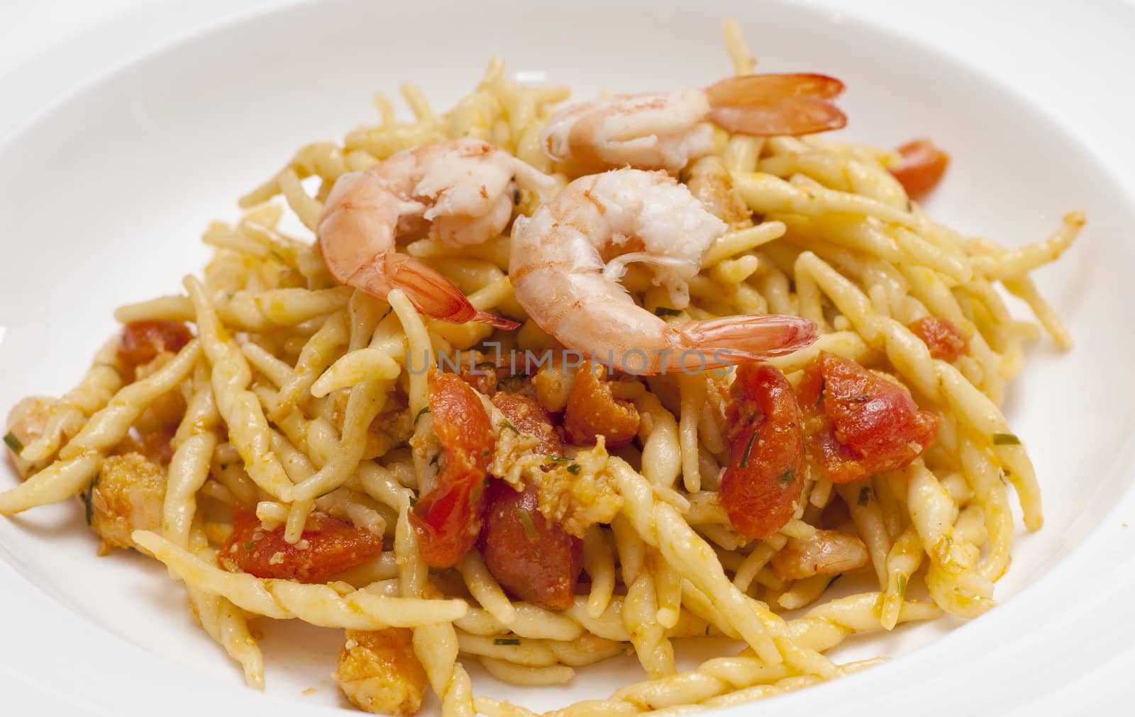 dish of pasta with a tomatoe shrimp sauce