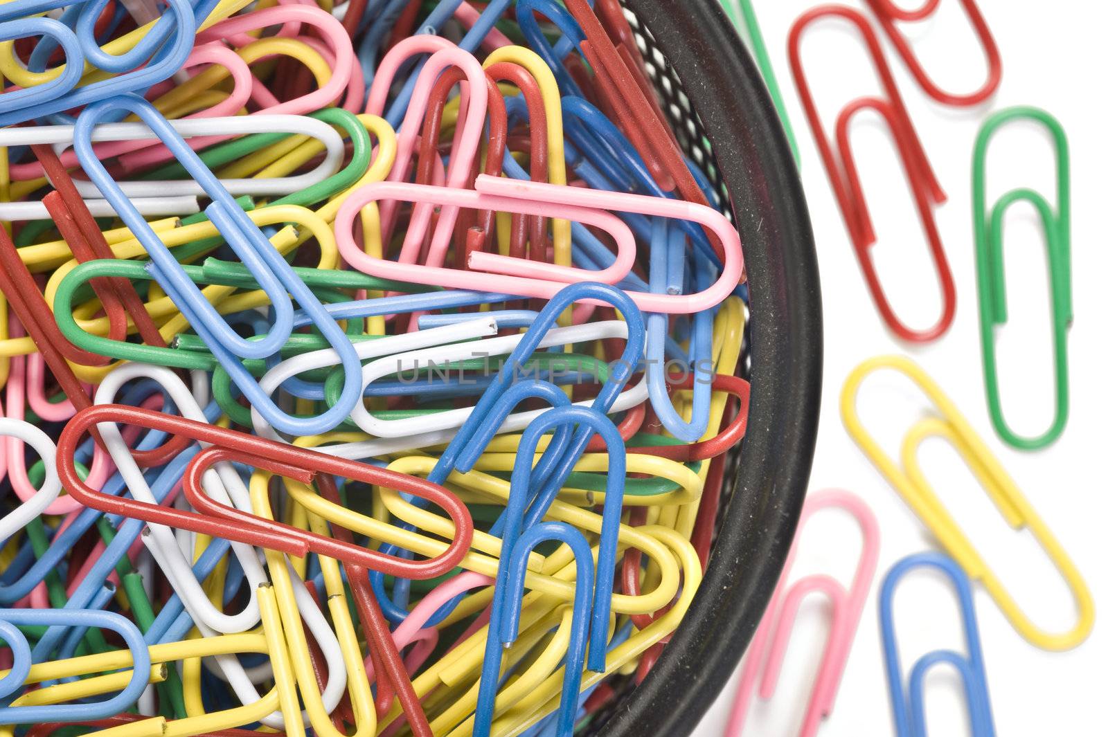 Colourful paper clips on a white background