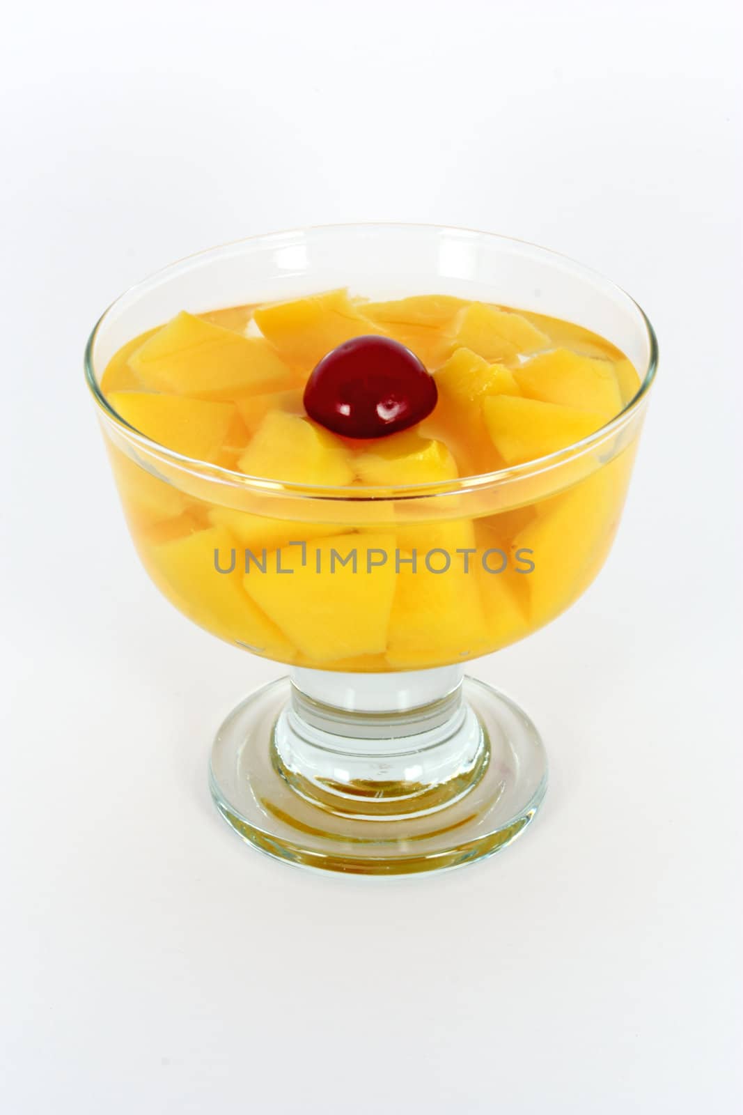 Peach compote with fresh sour cherry in glass isolated on white