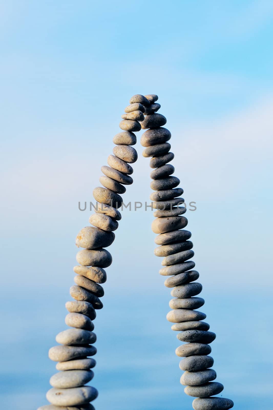 Pile of pebbles as pyramid against the background of sky