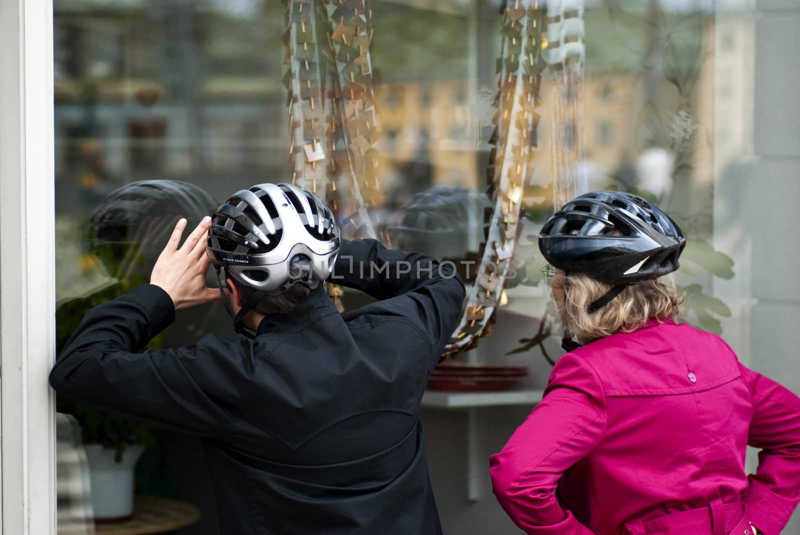 Two women wearing helmets windowshopping in Stockholm, Sweden. Picture taken May 16 2010