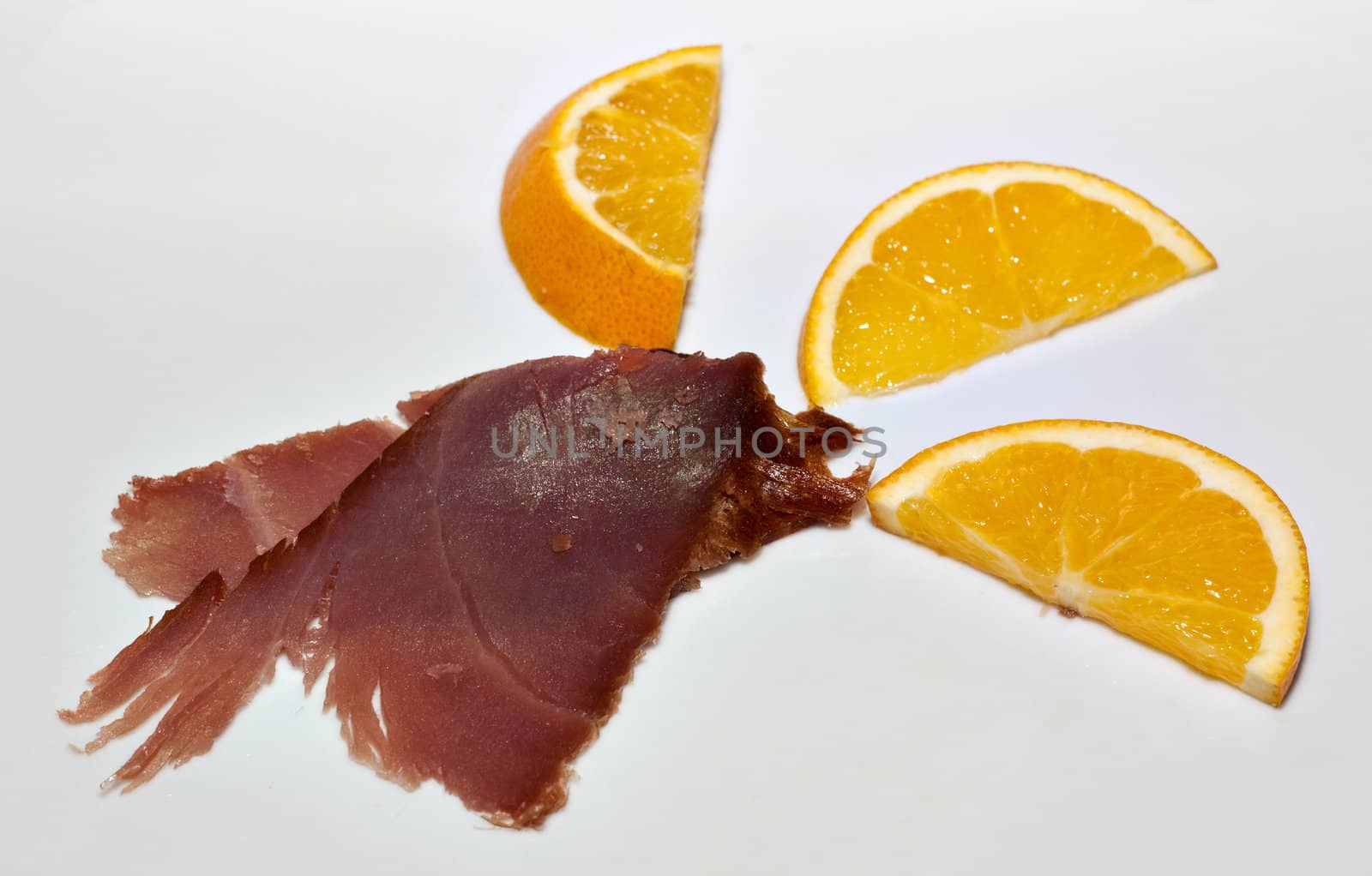 Slice of smoked tuna fish with orange slices